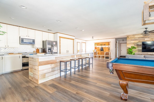 recreation room with ceiling fan, dark wood-type flooring, and billiards