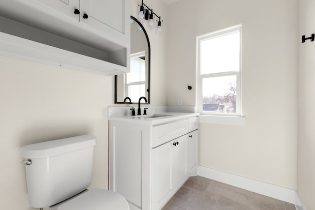 bathroom with tile patterned flooring, vanity, and toilet