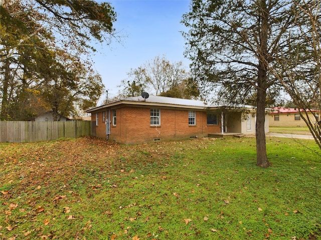 view of side of property with a yard