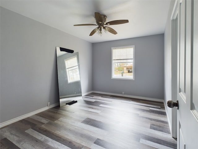 spare room with ceiling fan and dark wood-type flooring