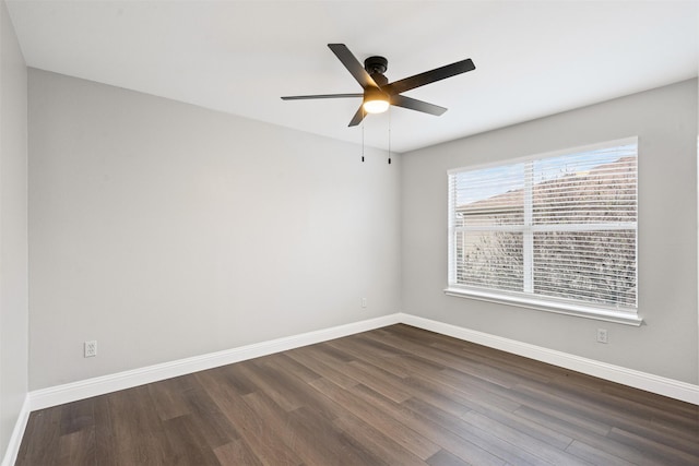 empty room with dark hardwood / wood-style floors and ceiling fan