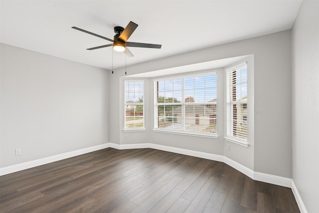 spare room with ceiling fan and dark wood-type flooring