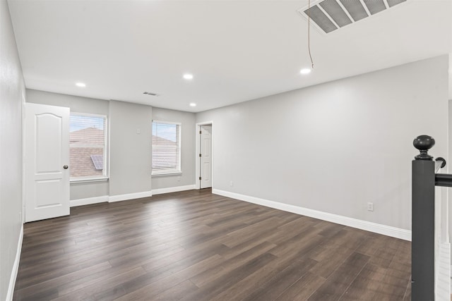 spare room with dark wood-type flooring