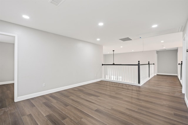 empty room with dark hardwood / wood-style flooring