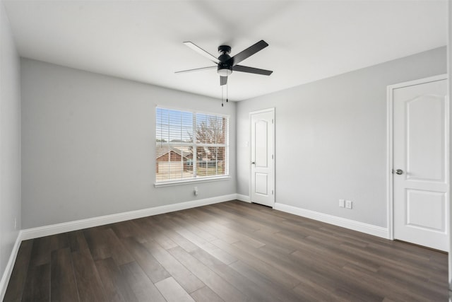 empty room with dark wood-type flooring and ceiling fan