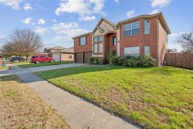 view of front of home featuring a garage and a front lawn