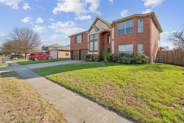 view of front of property featuring a garage and a front lawn