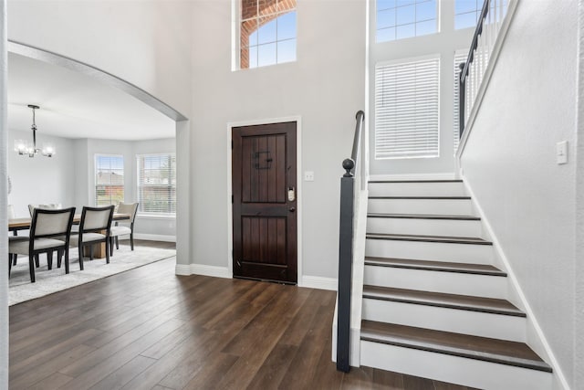 entrance foyer with a chandelier and dark hardwood / wood-style flooring