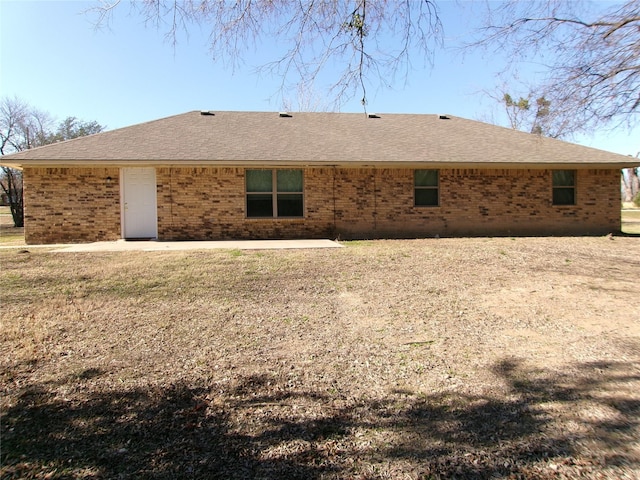 rear view of house with a lawn and a patio area