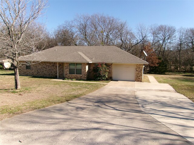 view of front facade with a garage and a front lawn