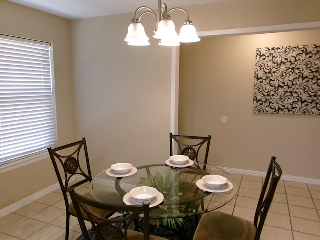 dining area featuring a chandelier and light tile patterned floors