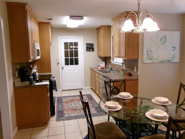 kitchen with backsplash, stainless steel dishwasher, sink, light tile patterned floors, and hanging light fixtures