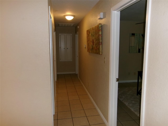 corridor with light tile patterned floors