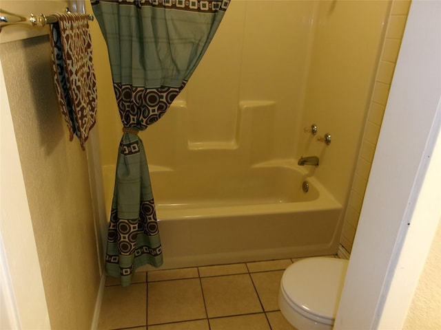 bathroom featuring toilet, bathing tub / shower combination, and tile patterned floors