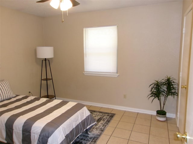 tiled bedroom featuring ceiling fan