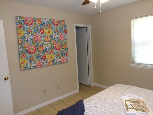 tiled bedroom with ceiling fan