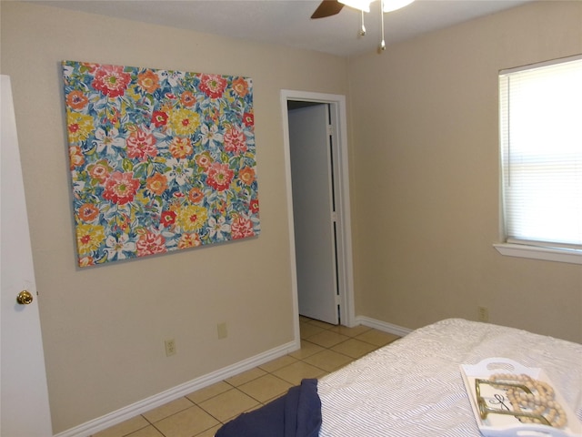 bedroom featuring light tile patterned floors and ceiling fan