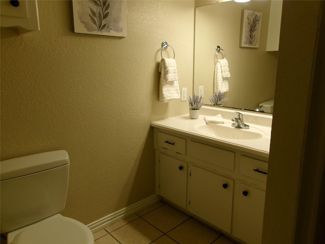 bathroom featuring toilet, vanity, and tile patterned floors