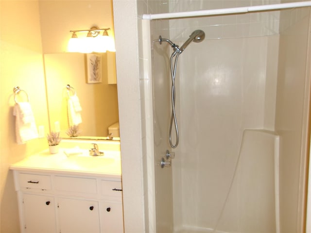 bathroom featuring vanity, toilet, and walk in shower