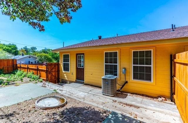 rear view of house featuring central AC unit and a patio