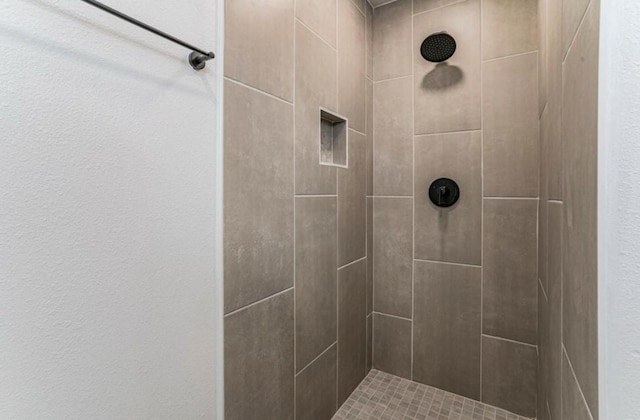 bathroom with tiled shower