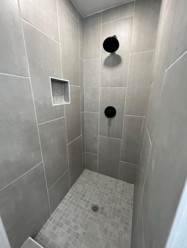 bathroom with tiled shower