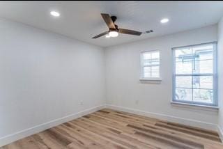 spare room with wood-type flooring, plenty of natural light, and ceiling fan