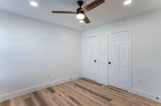 unfurnished bedroom with hardwood / wood-style floors and ceiling fan