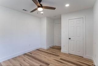 unfurnished bedroom with ceiling fan and light hardwood / wood-style floors