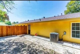 rear view of property with central AC