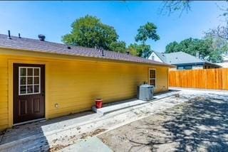 rear view of property with central AC