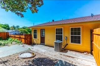 back of property featuring cooling unit and a patio area