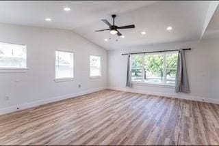 unfurnished room featuring ceiling fan, vaulted ceiling, and light hardwood / wood-style flooring