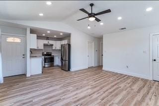 unfurnished living room with light wood-type flooring, vaulted ceiling, and ceiling fan