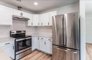 kitchen featuring white cabinets, stainless steel appliances, and light hardwood / wood-style floors