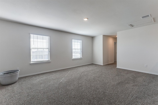 unfurnished room featuring dark colored carpet