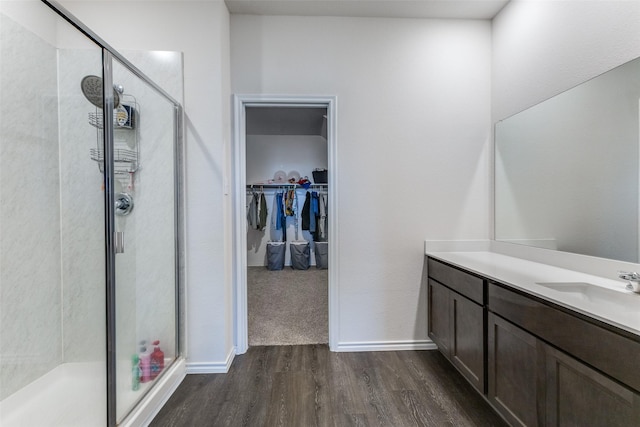 bathroom featuring hardwood / wood-style floors, vanity, and an enclosed shower