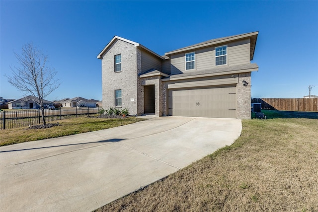 view of front of house with a front yard and a garage