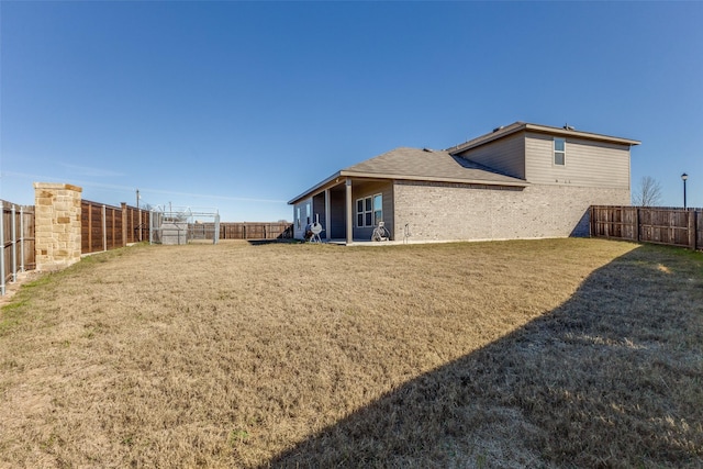 rear view of house with a yard