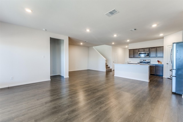 unfurnished living room with dark hardwood / wood-style floors