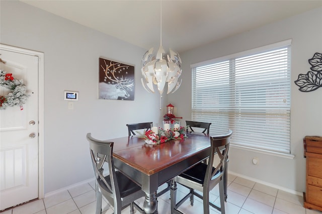 dining area with an inviting chandelier and light tile patterned floors