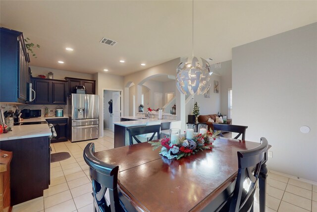 tiled dining space with an inviting chandelier