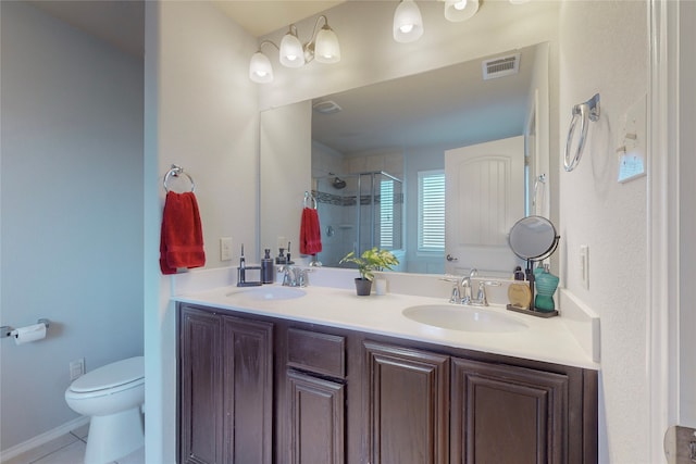 bathroom featuring vanity, tile patterned flooring, a shower with door, and toilet