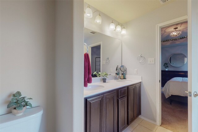 bathroom featuring tile patterned floors, toilet, and vanity