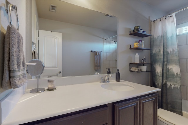 bathroom featuring vanity, toilet, and a shower with shower curtain