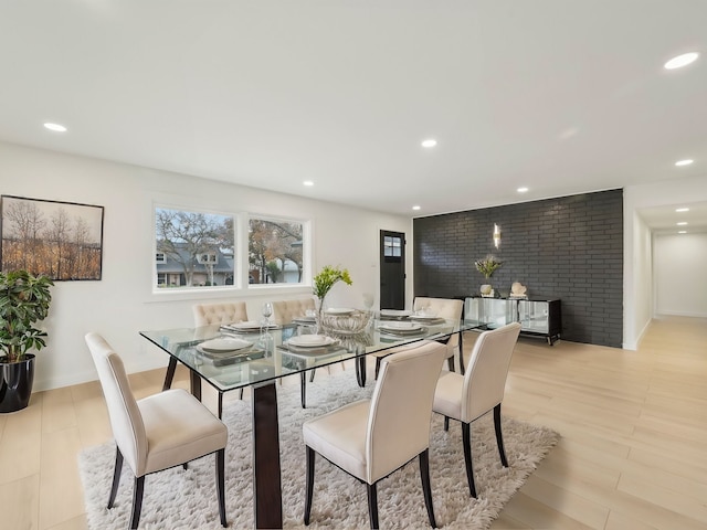 dining room featuring recessed lighting, baseboards, and light wood finished floors