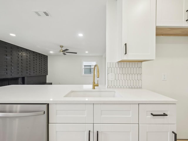 kitchen featuring a sink, visible vents, white cabinetry, light countertops, and stainless steel dishwasher