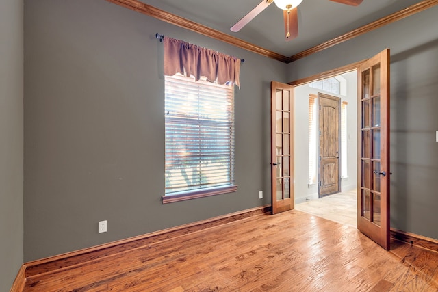 unfurnished room featuring baseboards, french doors, ornamental molding, and light wood-style floors