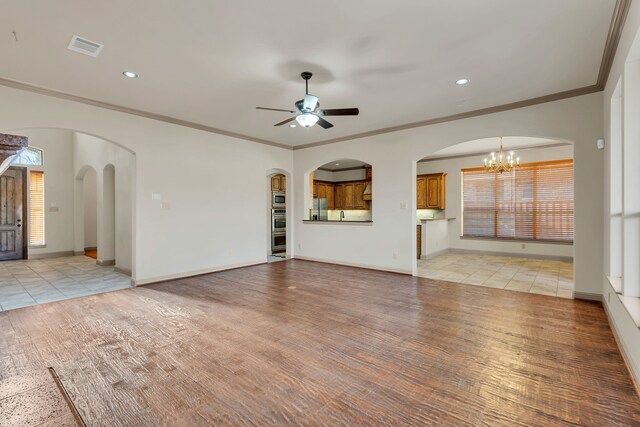 unfurnished living room featuring a stone fireplace, ceiling fan, crown molding, and light hardwood / wood-style floors