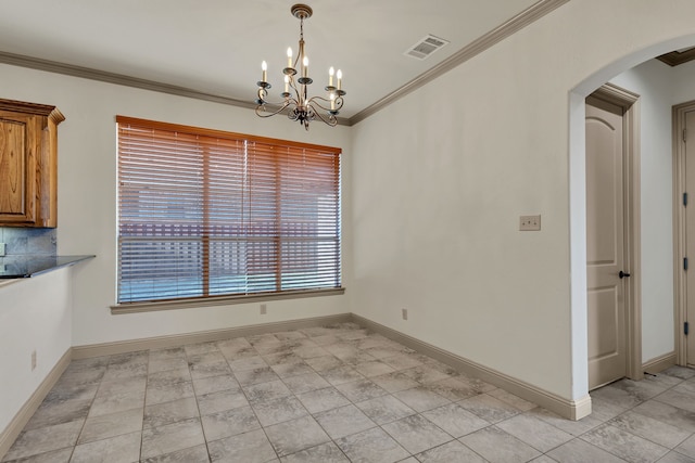 unfurnished dining area with light tile patterned floors, ornamental molding, and an inviting chandelier